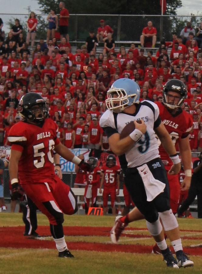 Varsity player, Cole Schaller, runs the ball trying to dodge Bloomingdale players at all cost.
